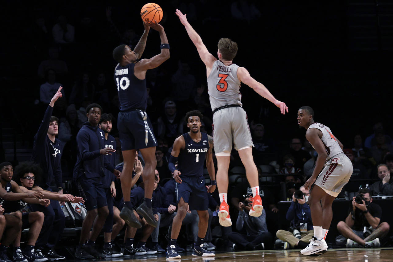 Xavier's Nate Johnson (10) shoots a 3-point basket in front of Virginia Tech's Sean Pedulla (3) in ...