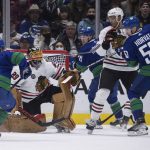 
              Chicago Blackhawks goalie Marc-Andre Fleury (29) makesa save as the puck bounces back past Vancouver Canucks' Bo Horvat (53) and Blackhawks' Seth Jones, second right, during first-period NHL hockey game action in Vancouver, British Columbia, Sunday, Nov. 21, 2021. (Darryl Dyck/The Canadian Press via AP)
            
