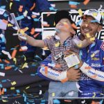 
              Kyle Larson, right, and his son Owen celebrate after winning a NASCAR Cup Series auto race and championship on Sunday, Nov. 7, 2021, in Avondale, Ariz. (AP Photo/Rick Scuteri)
            