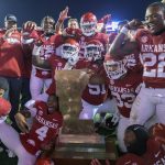 
              Arkansas players celebrate winning the Boot trophy, shaped like the state of Louisiana that celebrates the rivalry between Arkansas and LSU, after Arkansas' 16-13 win in overtime during an NCAA college football game in Baton Rouge, La., Saturday, Nov. 13, 2021. (AP Photo/Matthew Hinton)
            