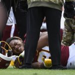 
              Washington Football Team defensive end Chase Young (99) is attended to after an injury during the first half of an NFL football game against the Tampa Bay Buccaneers, Sunday, Nov. 14, 2021, in Landover, Md.(AP Photo/Mark Tenally)
            
