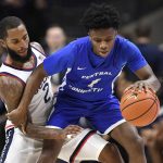 
              Connecticut's R.J. Cole pressures Central Connecticut State's Nigel Scantlebury, right, in the first half of an NCAA college basketball game, Tuesday, Nov. 9, 2021, in Storrs, Conn. (AP Photo/Jessica Hill)
            