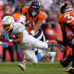
              Los Angeles Chargers running back Austin Ekeler (30) dives into the end zone for a touchdown as Denver Broncos inside linebacker Kenny Young (41) defends during the first half of an NFL football game, Sunday, Nov. 28, 2021, in Denver. (AP Photo/Jack Dempsey)
            