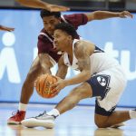 
              BYU guard Te'Jon Lucas (R) scrambles for the ball with Texas Southern guard PJ Henry (L) during the first half of an NCAA college basketball game Wednesday, Nov. 24 2021, in Provo, Utah. (AP Photo/George Frey)
            