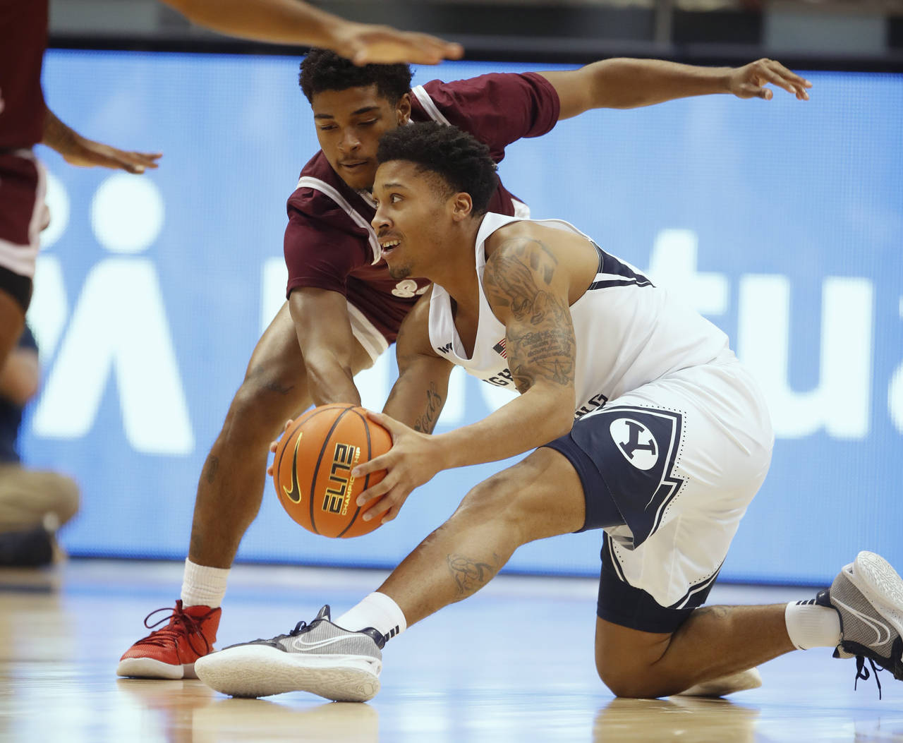 BYU guard Te'Jon Lucas (R) scrambles for the ball with Texas Southern guard PJ Henry (L) during the...