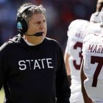 
              Mississippi State head coach Mike Leach talks with players during a timeout in the first half of an NCAA college football game against Auburn, Saturday, Nov. 13, 2021, in Auburn, Ala. (AP Photo/Butch Dill)
            
