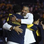 
              Michigan head coach Juwan Howard hugs forward Brandon Johns Jr. after presenting him with a Big Ten Conference championship ring before the NCAA college basketball game against Buffalo, Wednesday, Nov. 10, 2021, in Ann Arbor, Mich. (AP Photo/Lon Horwedel)
            
