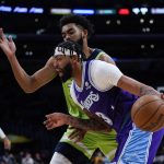 
              Los Angeles Lakers' Anthony Davis, front, drives past Minnesota Timberwolves' Karl-Anthony Towns during the first half of an NBA basketball game Friday, Nov. 12, 2021, in Los Angeles. (AP Photo/Jae C. Hong)
            