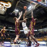 
              Pittsburgh's Femi Odukale, center, shoots between Minnesota's Jamison Battle, center left, and Charlie Daniels (15) during the first half of an NCAA college basketball game Tuesday, Nov. 30, 2021, in Pittsburgh. (AP Photo/Keith Srakocic)
            