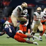 
              UAB running back DeWayne McBride (22) is upended by UTSA safety Antonio Parks (4) during the second half of an NCAA college football game, Saturday, Nov. 20, 2021, in San Antonio. (AP Photo/Eric Gay)
            