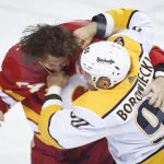 
              Nashville Predators' Mark Borowiecki, right, fights with Calgary Flames' Brett Ritchie during the first period of an NHL hockey game Tuesday, Nov. 2, 2021, in Calgary, Alberta. Jeff McIntosh/The Canadian Press via AP)
            