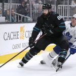 
              San Jose Sharks defenseman Brent Burns (88) moves the puck past Toronto Maple Leafs center Mitchell Marner (16) during the second period of an NHL hockey game Friday, Nov. 26, 2021, in San Jose, Calif. (AP Photo/Tony Avelar)
            