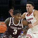 
              Texas A&M guard Quenton Jackson (3) drives on Wisconsin guard Johnny Davis in the first half of an NCAA college basketball game at the Maui Invitational in Las Vegas, Monday, Nov. 22, 2021. (AP Photo/Rick Scuteri)
            