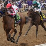 
              Mike Smith, left, rides Corniche to win the Breeders' Cup Juvenile horse race at the Del Mar racetrack in Del Mar, Calif., Friday, Nov. 5, 2021. (AP Photo/Gregory Bull)
            