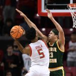 
              Maryland guard Eric Ayala (5) goes to the basket against George Mason forward Josh Oduro (13) during the first half of an NCAA college basketball game Wednesday, Nov. 17, 2021, in College Park, Md. (AP Photo/Nick Wass)
            