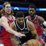 
              Detroit Pistons forward Kelly Olynyk, left, reaches in on Brooklyn Nets forward Bruce Brown (1) during the first half of an NBA basketball game, Friday, Nov. 5, 2021, in Detroit. (AP Photo/Carlos Osorio)
            