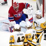 
              Montreal Canadiens goaltender Cayden Primeau kneels in front of his net as Pittsburgh Penguins' Danton Heinen, center, celebrates his goal with teammates Kasperi Kapanen, left, and Jason Zucker during first-period NHL hockey action in Montreal, Thursday, Nov. 18, 2021. (Paul Chiasson/The Canadian Press via AP)
            