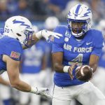 
              Air Force quarterback Haaziq Daniels (4) hands off to running back Brad Roberts (20 ) in the first half against  Army during an NCAA college football game in Arlington, Texas, Saturday, Nov. 6, 2021. (AP Photo/Tim Heitman)
            