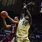 
              Florida State guard Caleb Mills (4) shoots over Purdue forward Trevion Williams (50) Florida State guard Caleb Mills (4) shoots over Purdue forward Trevion Williams (50) during the first half of an NCAA college basketball game in West Lafayette, Ind., Tuesday, Nov. 30, 2021. (AP Photo/Michael Conroy)
            