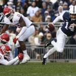 
              Rutgers defensive lineman Aaron Lewis (71) tries to tackle Penn State quarterback Sean Clifford (14) during the first half of an NCAA college football game in State College, Pa., Saturday, Nov. 20, 2021. (AP Photo/Barry Reeger)
            