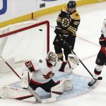 
              Boston Bruins' Brad Marchand deflects a shot past Ottawa Senators goaltender Matt Murray for a goal during the second period of an NHL hockey game Tuesday, Nov. 9, 2021, in Boston. (AP Photo/Winslow Townson)
            