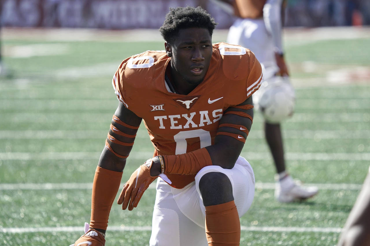 FILE -  Texas linebacker DeMarvion Overshown pauses after taking the field before an NCAA college f...