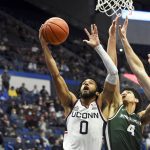 
              Connecticut's Jalen Gaffney (0) goes up for two against Binghamton's Kellen Amos (4) and Yarden Willis (44) during the first half of an NCAA college basketball game Saturday, Nov. 20, 2021, in Hartford, Conn. (AP Photo/Stephen Dunn)
            