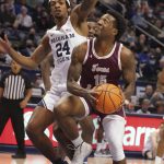 
              Texas Southern forward Justin Hopkins (15) looks to shoot as BYU forward Seneca Knight (24) defends during the first half of an NCAA college basketball game Wednesday, Nov. 24 2021, in Provo, Utah. (AP Photo/George Frey)
            