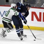 
              Winnipeg Jets' Pierre-Luc Dubois (80) is checked by Dallas Stars' Ryan Suter (20) during the first period of an NHL hockey game Tuesday, Nov. 2, 2021, in Winnipeg, Manitoba. (Fred Greenslade/The Canadian Press via AP)
            
