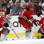 
              Carolina Hurricanes goaltender Alex Lyon (34) freezes the puck as teammates Ethan Bear (25) and Jaccob Slavin (74) defends against St. Louis Blues' Pavel Buchnevich (89) during the second period of an NHL hockey game in Raleigh, N.C., Saturday, Nov. 13, 2021. (AP Photo/Karl B DeBlaker)
            