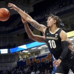 
              Vanderbilt's Myles Stute (10) reaches for a rebound in front of Pittsburgh's William Jeffress during the first half of an NCAA college basketball game, Wednesday, Nov. 24, 2021, in Pittsburgh. (AP Photo/Keith Srakocic)
            