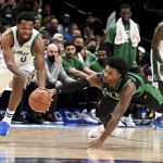 
              Boston Celtics guard Marcus Smart, right, goes for the steal on Dallas Mavericks forward Sterling Brown (0)  during the first half of an NBA basketball game in Dallas, Saturday, Nov. 6, 2021. (AP Photo/Matt Strasen)
            
