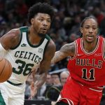 
              Boston Celtics' Marcus Smart (36) drives past Chicago Bulls' DeMar DeRozan (11) during the second half of an NBA basketball game, Monday, Nov. 1, 2021, in Boston. (AP Photo/Michael Dwyer)
            