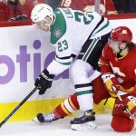 
              Dallas Stars' Esa Lindell, left, reaches for the puck next to Calgary Flames' Andrew Mangiapane during the second period of an NHL hockey game Thursday, Nov. 4, 2021, in Calgary, Alberta. (Larry MacDougal/The Canadian Press via AP)
            