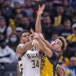
              Indiana Pacers guard Chris Duarte (3) and Milwaukee Bucks forward Giannis Antetokounmpo (34) battle for the ball during the first half of an NBA basketball game in Indianapolis, Sunday, Nov. 28, 2021. (AP Photo/Doug McSchooler)
            