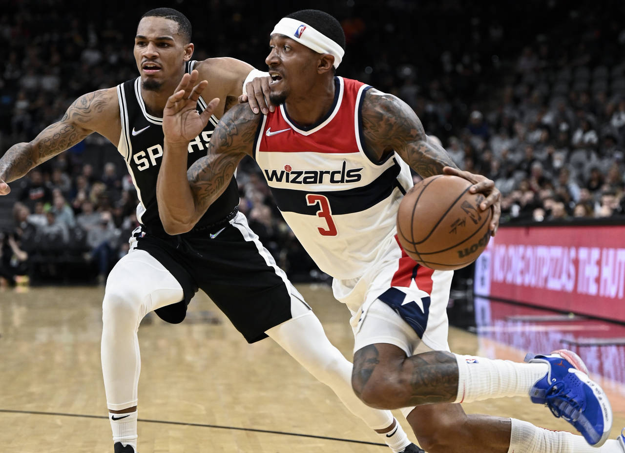 Washington Wizards' Bradley Beal (3) drives against San Antonio Spurs' Dejounte Murray during the f...
