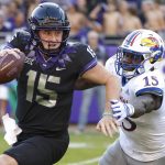 
              TCU quarterback Max Duggan, left, tries to scramble away from Kansas defensive end Kyron Johnson during the first half of an NCAA college football game Saturday, Nov. 20, 2021, in Fort Worth, Texas. (AP Photo/Ron Jenkins)
            
