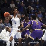 
              Tennessee Tech's John Pettway center, defends as Memphis Emoni Bates looks for an outlet in the first half of an NCAA college basketball game Tuesday, Nov. 9, 2021, in Memphis, Tenn. (AP Photo/Karen Pulfer Focht)
            