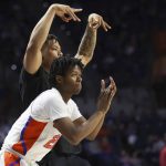 
              Florida guard Tyree Appleby (22) and Keyontae Johnson, top, celebrate a three-point basket against Troy during the second half of an NCAA college basketball game Sunday, Nov. 28, 2021, in Gainesville, Fla. (AP Photo/Matt Stamey)
            
