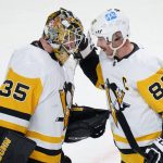 
              Pittsburgh Penguins captain Sidney Crosby celebrates with teammate goaltender Tristan Jarry after their victory over the Montreal Canadiens in NHL hockey game action in Montreal, Thursday, Nov. 18, 2021. (Paul Chiasson/The Canadian Press via AP)
            