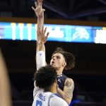 
              North Florida guard Jacob Crews, right, shoots as UCLA guard Johnny Juzang defends during the first half of an NCAA college basketball game Wednesday, Nov. 17, 2021, in Los Angeles. (AP Photo/Mark J. Terrill)
            
