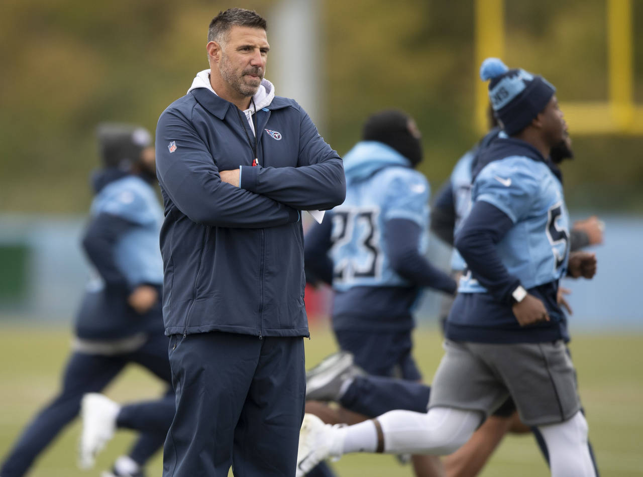Tennessee Titans NFL football head coach Mike Vrabel watches his players run sprints during practic...