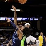 
              Memphis Grizzlies guard Ja Morant (12) is fouled by Minnesota Timberwolves guard Patrick Beverley in the second half of an NBA basketball game, Monday, Nov. 8, 2021, in Memphis, Tenn. (AP Photo/Brandon Dill)
            