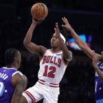 
              Chicago Bulls guard Ayo Dosunmu, center, shoots as Los Angeles Lakers center Dwight Howard, left, and guard Malik Monk defend during the first half of an NBA basketball game Monday, Nov. 15, 2021, in Los Angeles. (AP Photo/Mark J. Terrill)
            