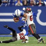 
              Indianapolis Colts' Jonathan Taylor (28) is tackled by Tampa Bay Buccaneers' Sean Murphy-Bunting (23) and Lavonte David (54) during the first half of an NFL football game, Sunday, Nov. 28, 2021, in Indianapolis. (AP Photo/AJ Mast)
            