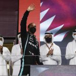 
              Mercedes driver Lewis Hamilton of Britain waves from the podium after winning the Qatar Formula One Grand Prix. In Lusail, Qatar, Sunday, Nov. 21, 2021. (Hamad I Mohammed, Pool via AP)
            