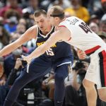 
              Denver Nuggets center Nikola Jokic, left, fights off Portland Trail Blazers center Cody Zeller  who tries to steal the ball in the first half of an NBA basketball game Sunday, Nov. 14, 2021, in Denver. (AP Photo/David Zalubowski)
            