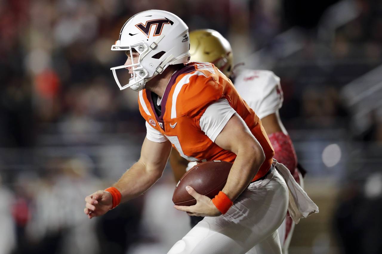 Virginia Tech quarterback Braxton Burmeister (3) carries the ball during the first half of an NCAA ...
