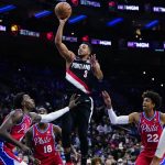 
              Portland Trail Blazers' CJ McCollum (3) goes up for a shot against Philadelphia 76ers' Paul Reed, from left, Shake Milton and Matisse Thybulle during the first half of an NBA basketball game, Monday, Nov. 1, 2021, in Philadelphia. (AP Photo/Matt Slocum)
            