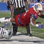 
              Kansas running back Devin Neal (4) is tackled by Kansas cornerback Duece Mayberry (22) during the second half of an NCAA football game Saturday, Nov. 6, 2021, in Lawrence, Kan. (AP Photo/Charlie Riedel)
            